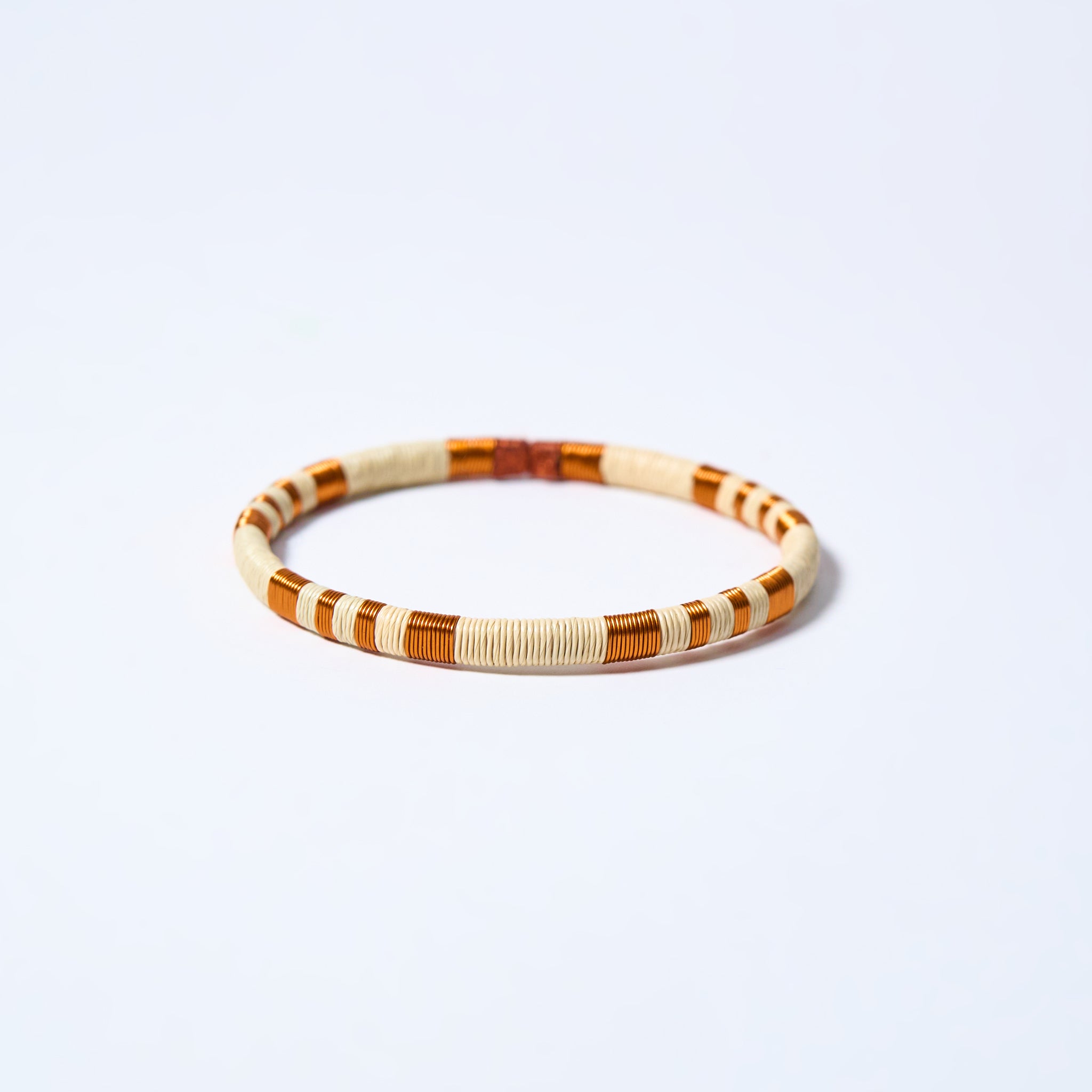 Handmade striped bracelet with copper and cream pattern