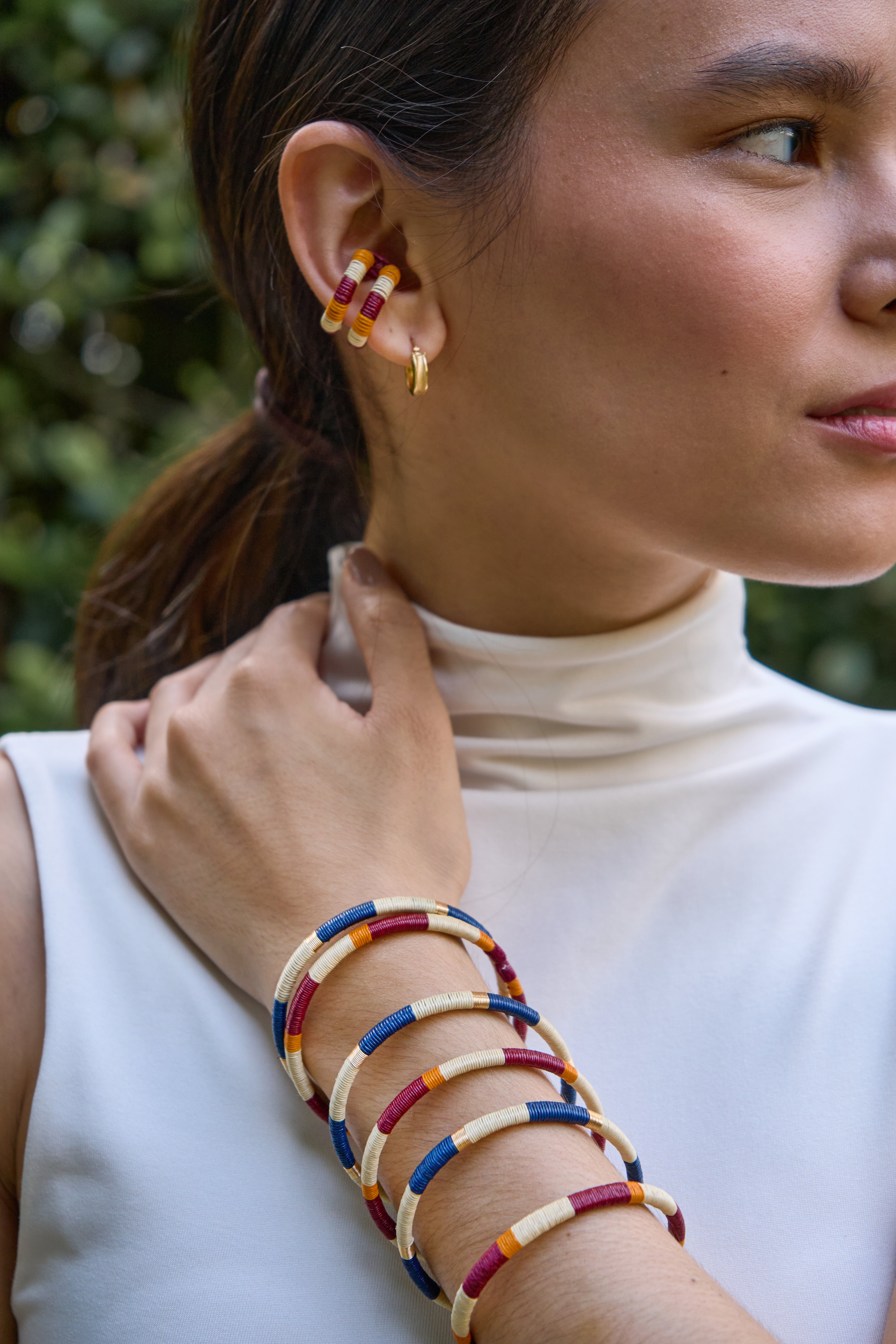 Woman wearing colorful handmade beaded bracelet and earrings
