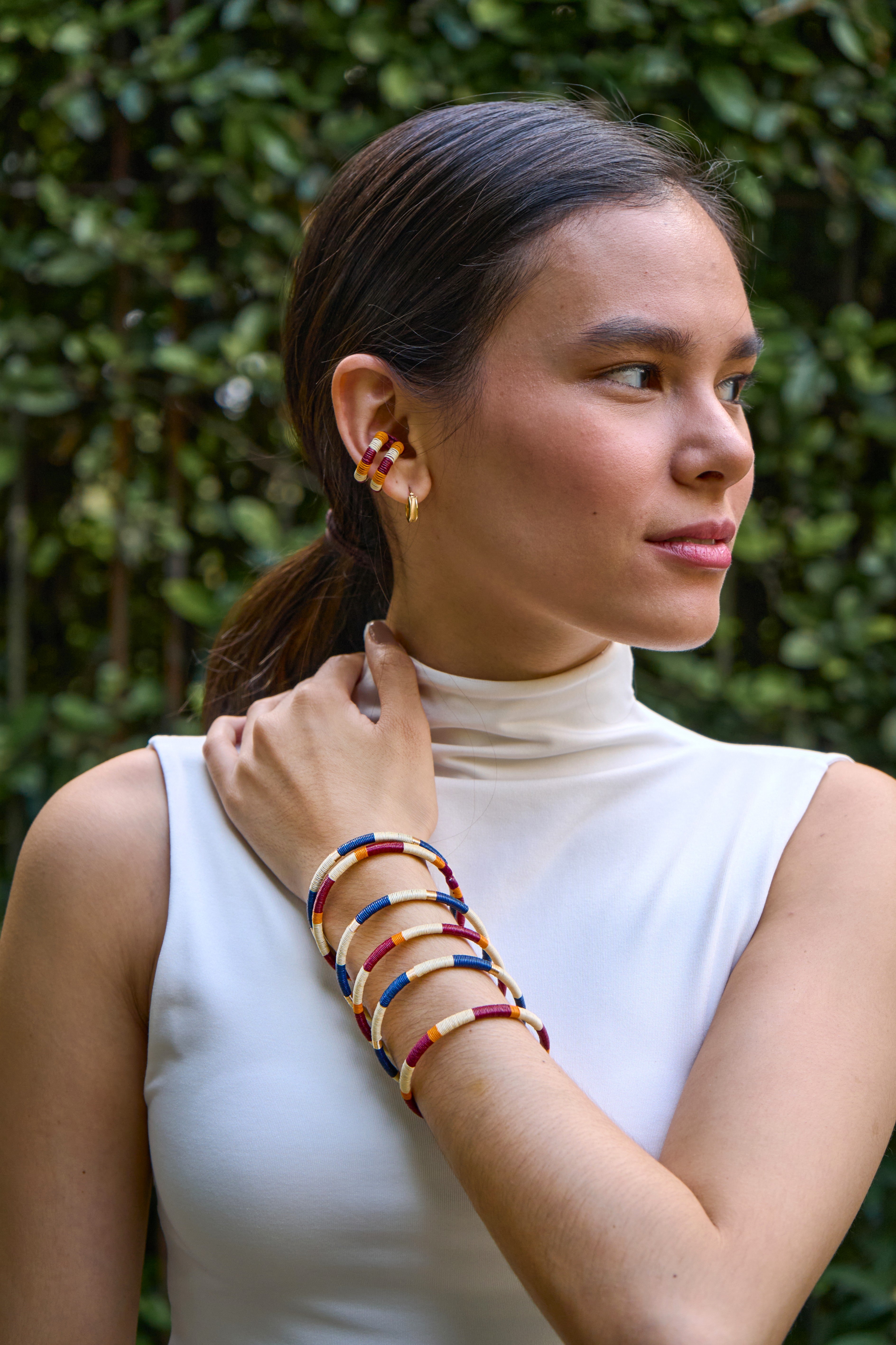 Model Set of handmade striped bracelets in cream, copper, blue, wine and gold