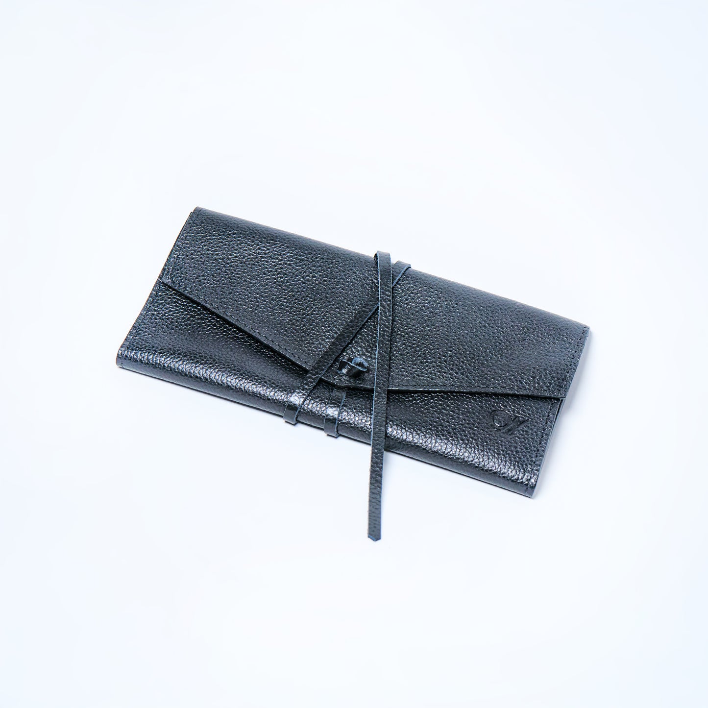 Black Onyx leather wallet on a light gray background. handcrafted by Oda Nova with space for 8 cards and bills