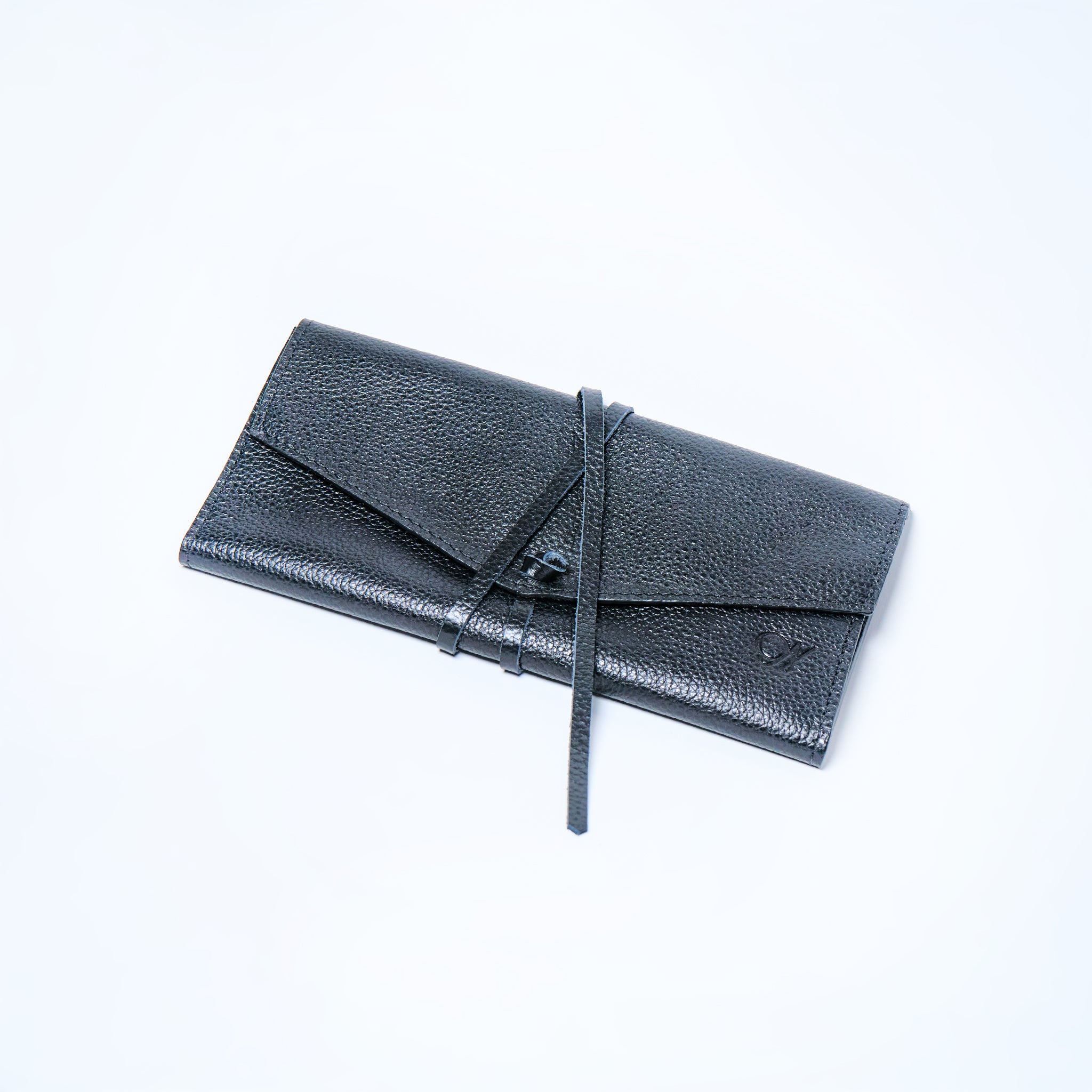 Black Onyx leather wallet on a light gray background. handcrafted by Oda Nova with space for 8 cards and bills