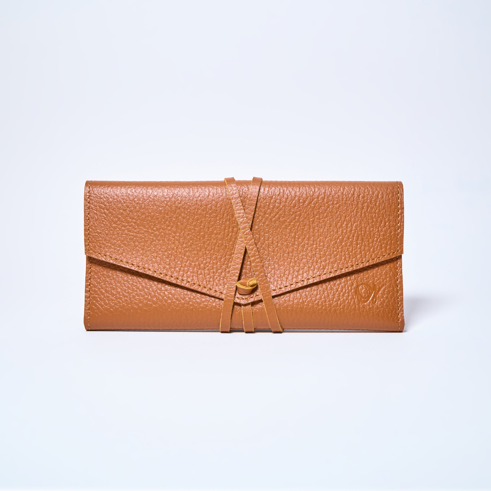 Brown leather wallet on a light gray background. handcrafted by Oda Nova with space for 8 cards and bills