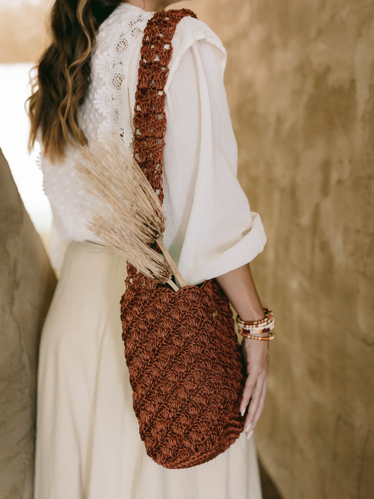 Women wearing handmade woven bag terracota