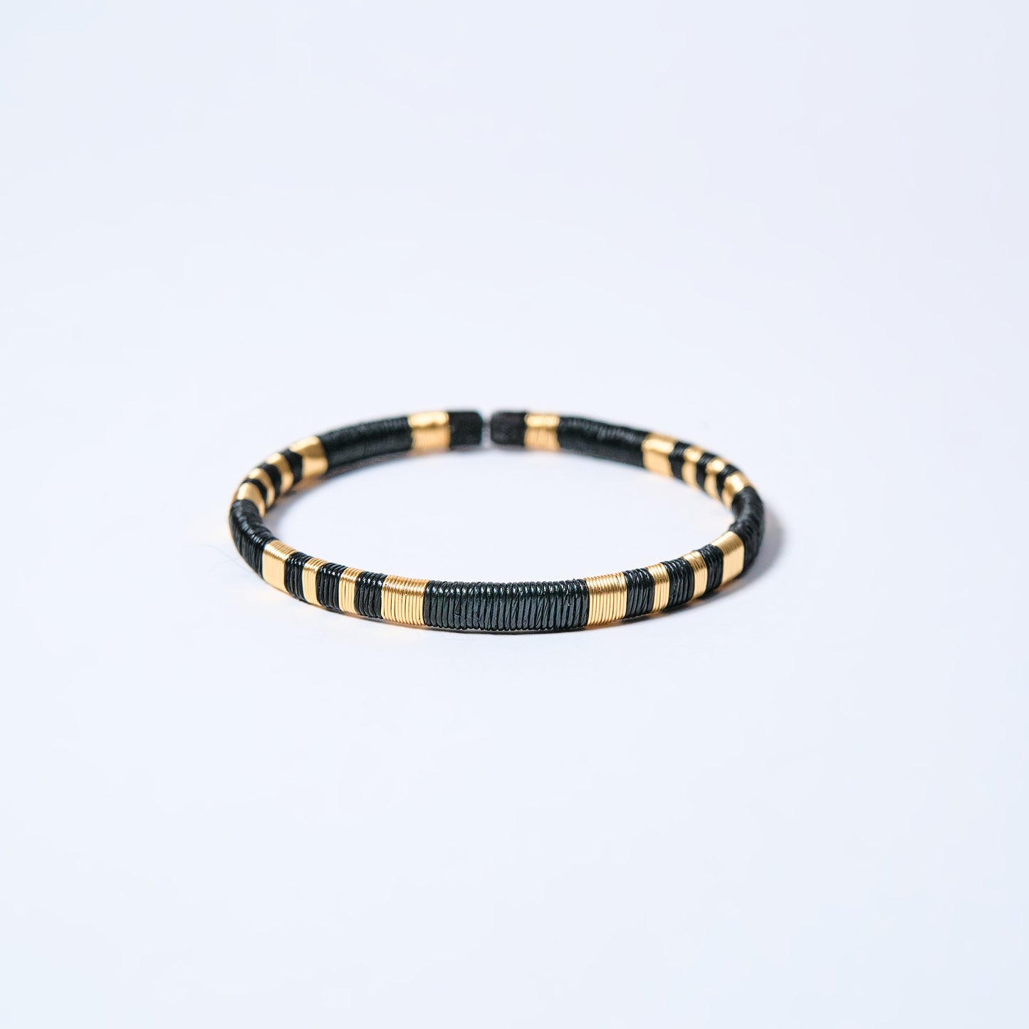 Handmade striped bracelet with black and gold pattern