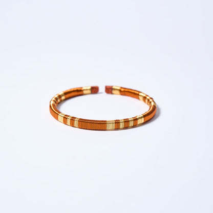 Handmade striped bracelet with copper and gold pattern