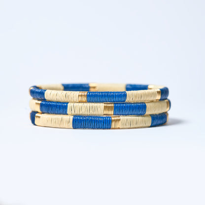 Set of  handmade striped bracelets in cream, blue and gold