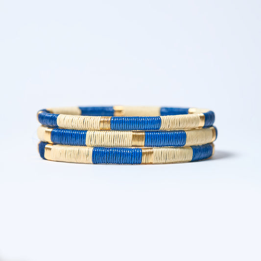 Set of  handmade striped bracelets in cream, blue and gold