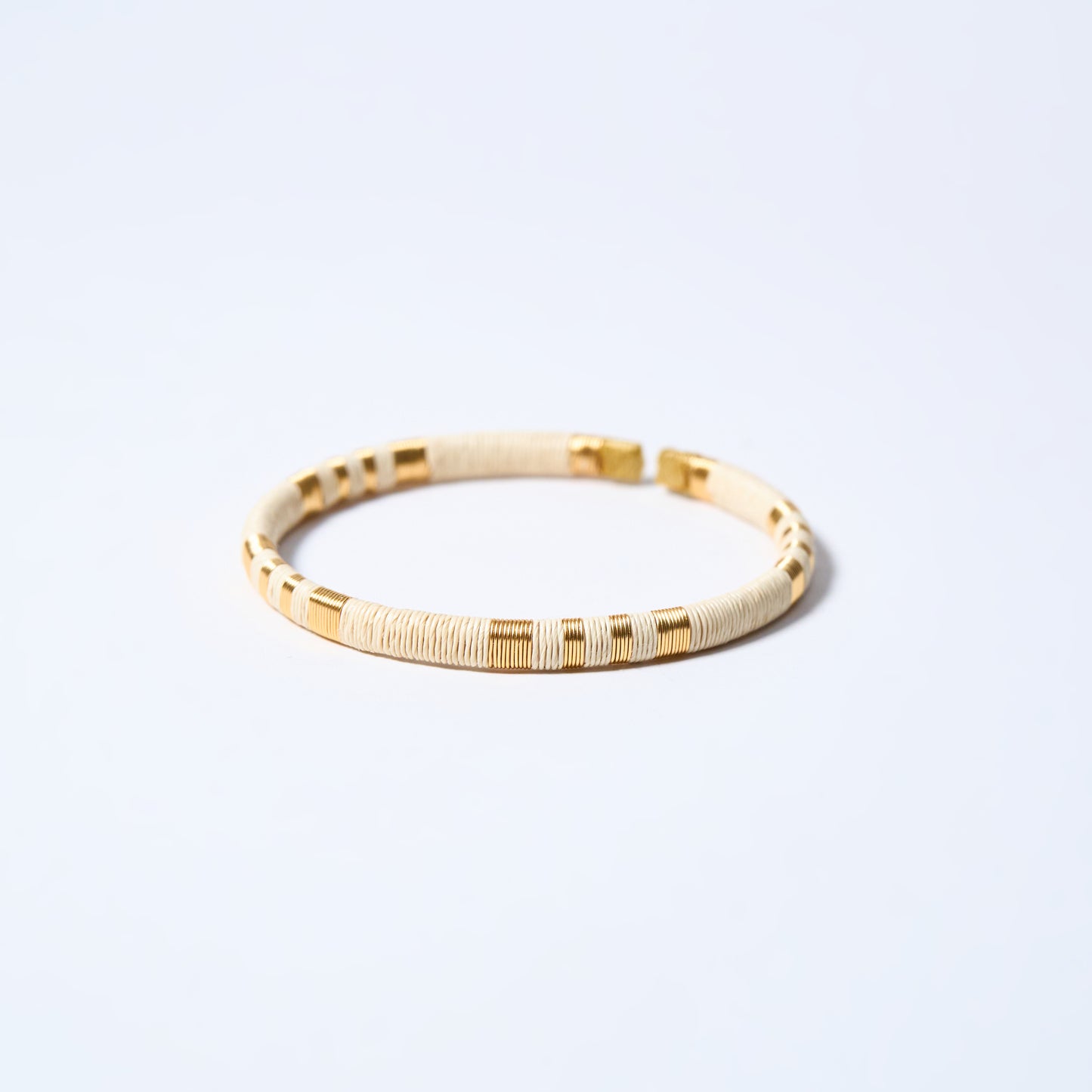 Handmade striped bracelet with cream and gold pattern