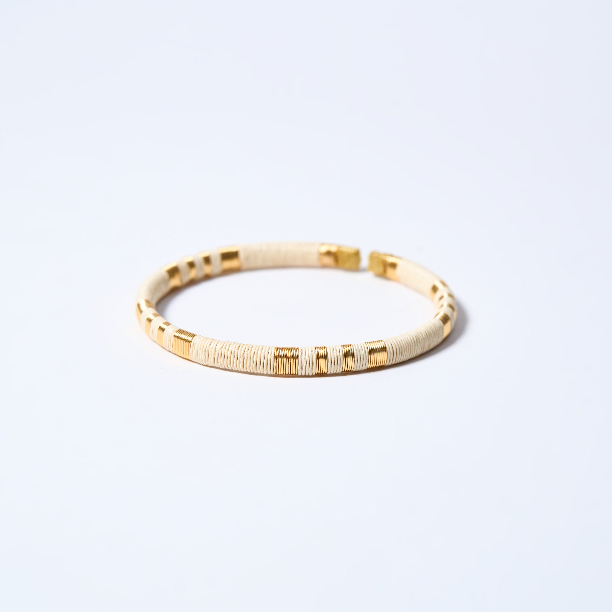 Handmade striped bracelet with cream and gold pattern