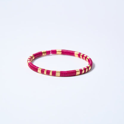 Handmade striped bracelet with fuchsia and gold pattern