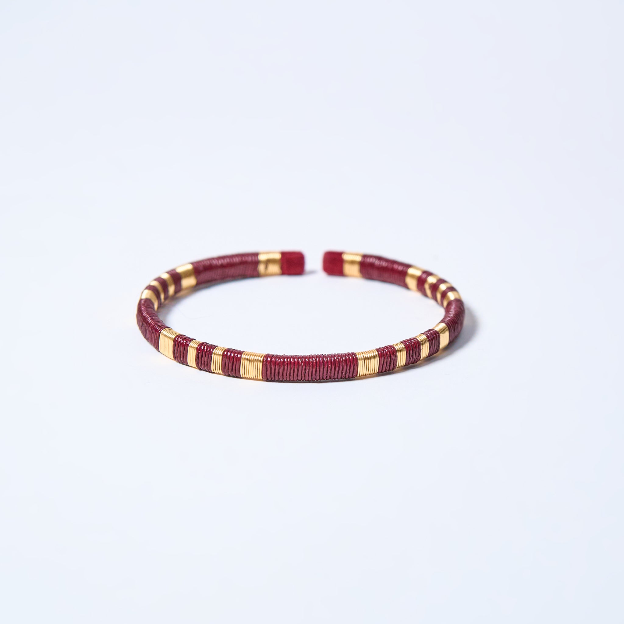 Handmade striped bracelet with wine red and gold pattern