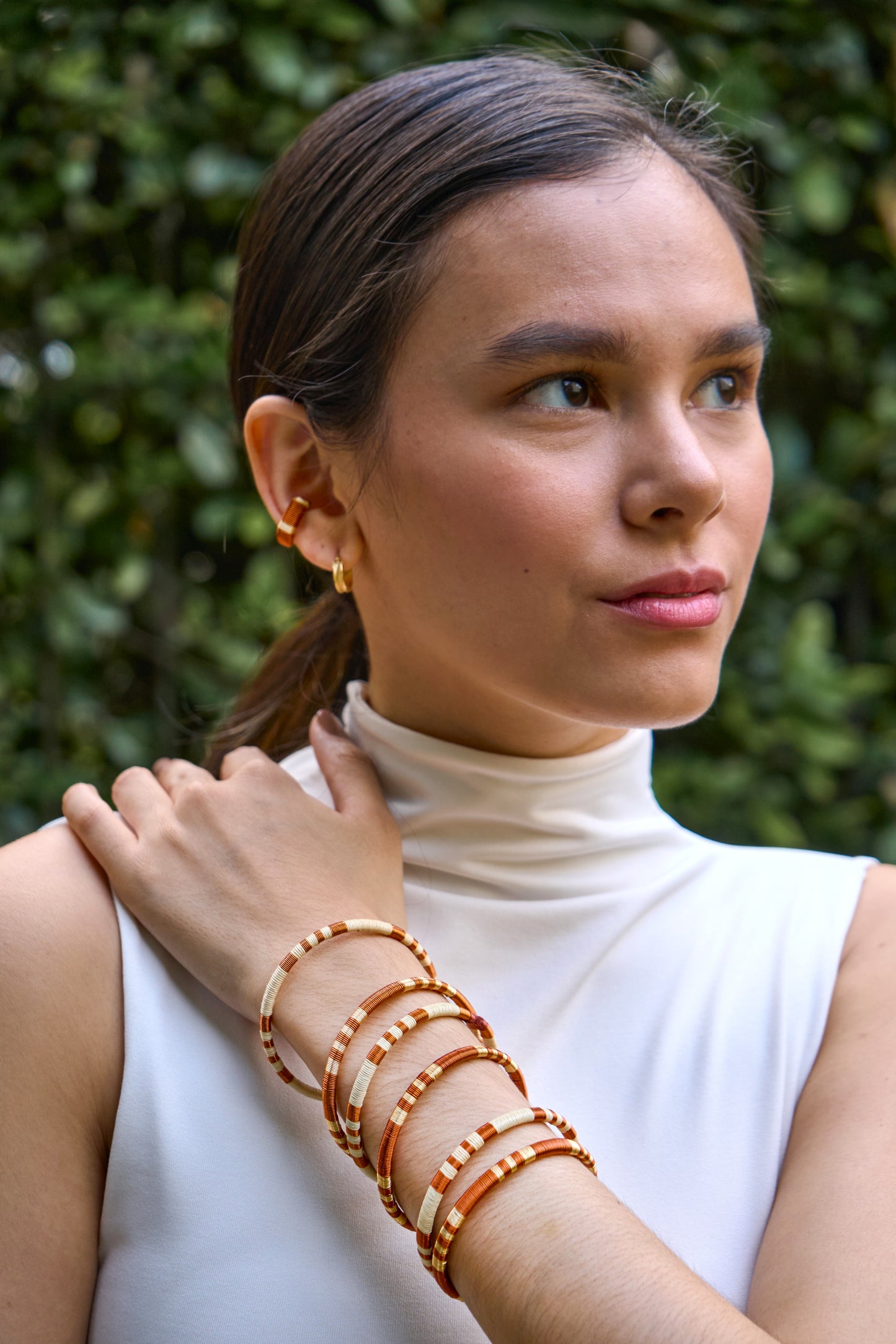 Model Set of  handmade striped bracelets in cream, copper and gold