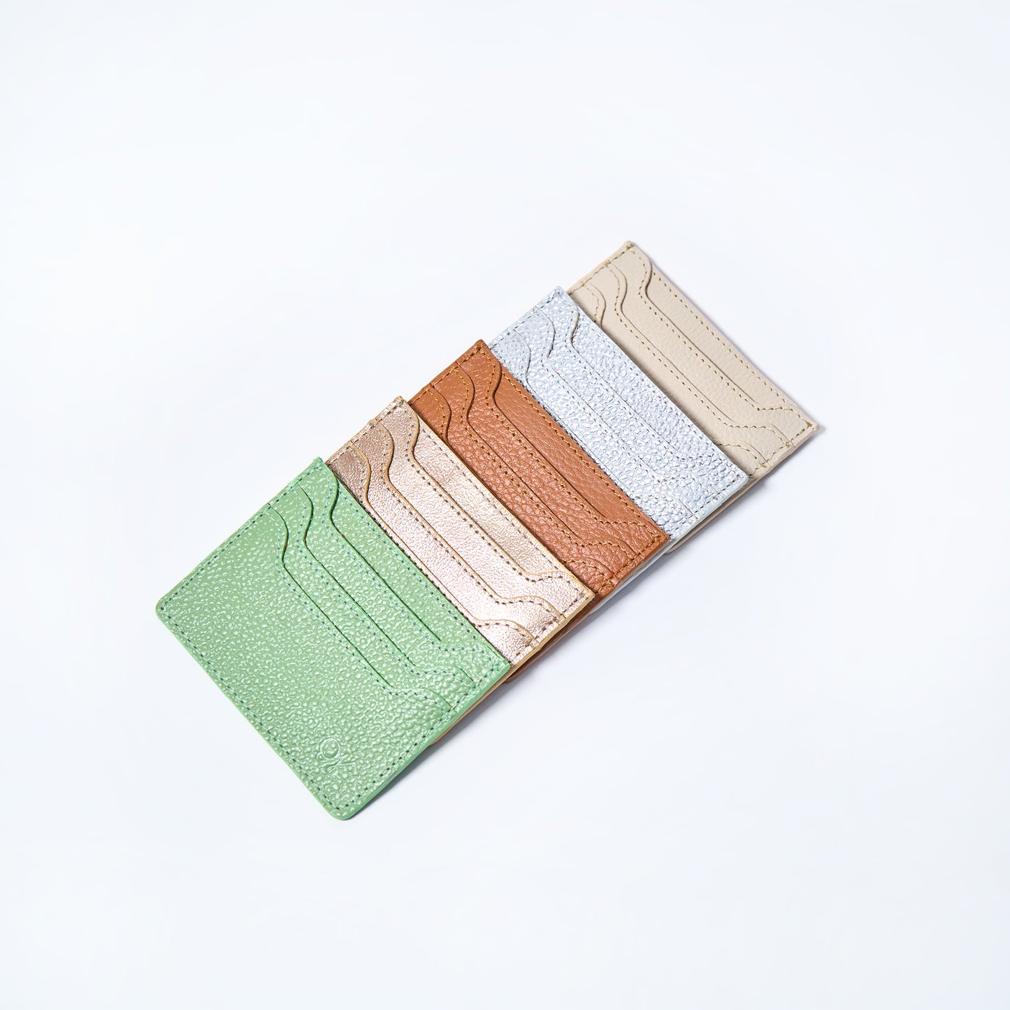 Set of five Celeste slim leather wallet handcrafted by Oda Nova with 6 card slots, sleek and minimalist design in various colors on a white background