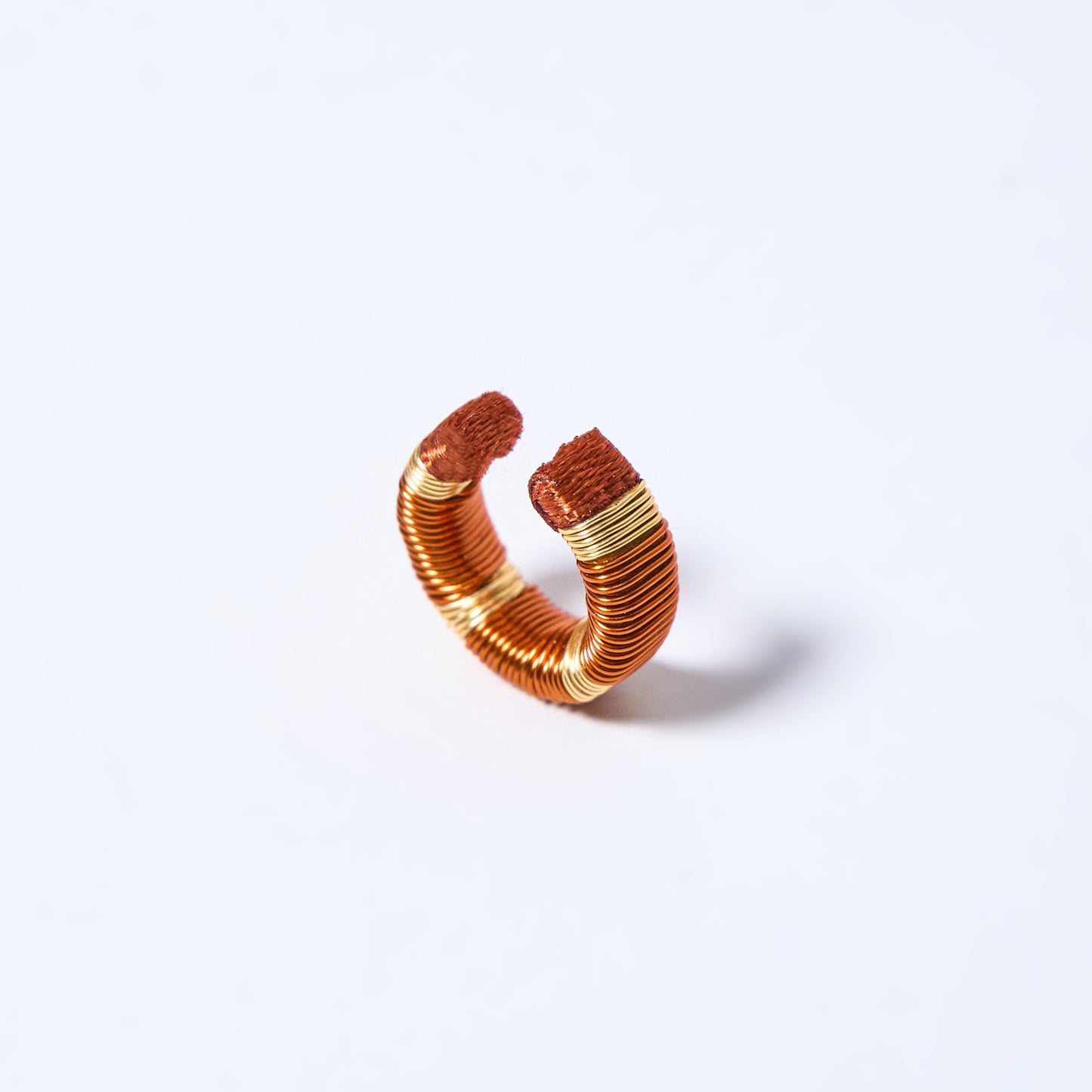 Handmade ear cuff striped in gold and copper
