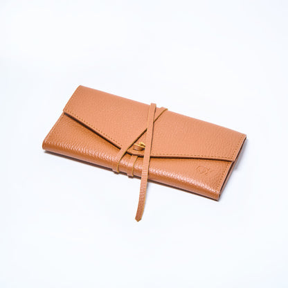 Honey brown leather wallet closed on a light gray background. handcrafted by Oda Nova with space for 8 cards and bills