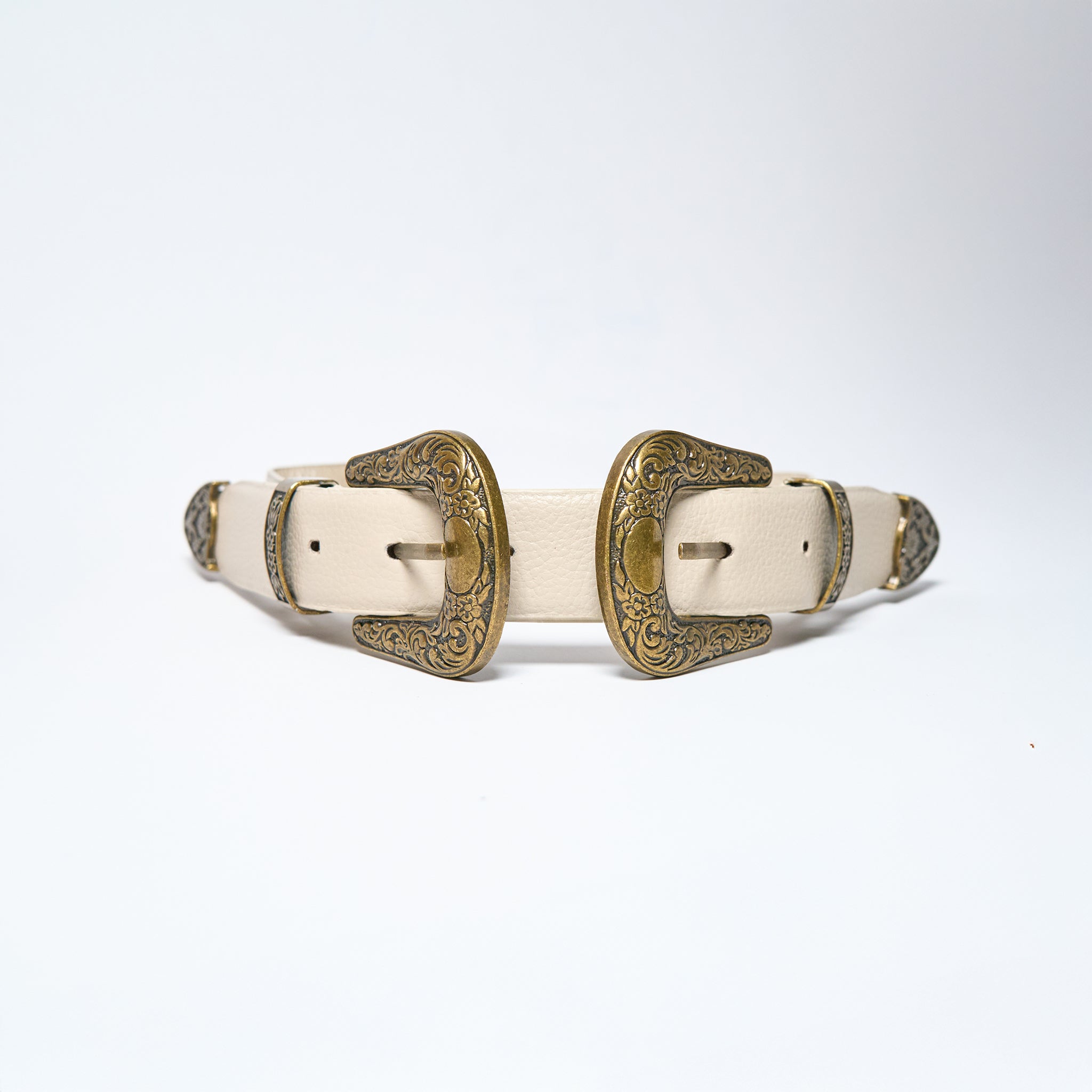 Pair of white leather belts with gold buckles on a light gray background