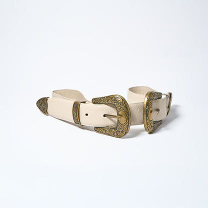 White belt with gold buckle on a light gray background