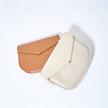 Two Lyra convertible leather crossbody bag in Honey Brown & Cream with adjustable strap, can be worn as a shoulder bag, crossbody, or belt bag. Handcrafted by Oda Nova