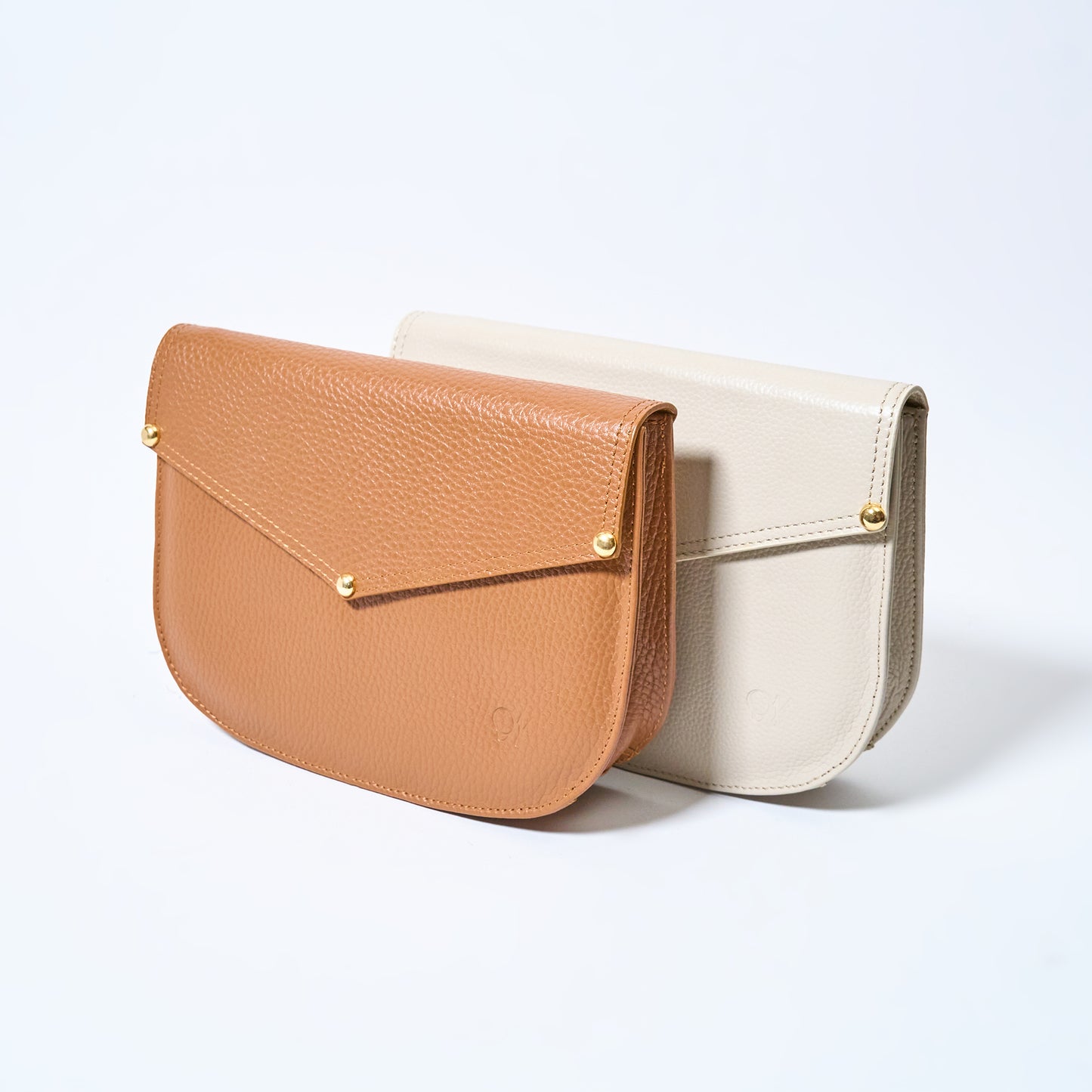 Two Lyra convertible leather crossbody bag in Honey Brown & Cream with adjustable strap, can be worn as a shoulder bag, crossbody, or belt bag. Handcrafted by Oda Nova